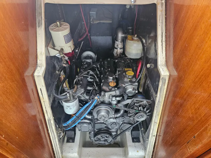 Slide: The Image of Engine compartment of a 1990 Catalina 42 sailboat, showcasing mechanical components and wiring. - 33