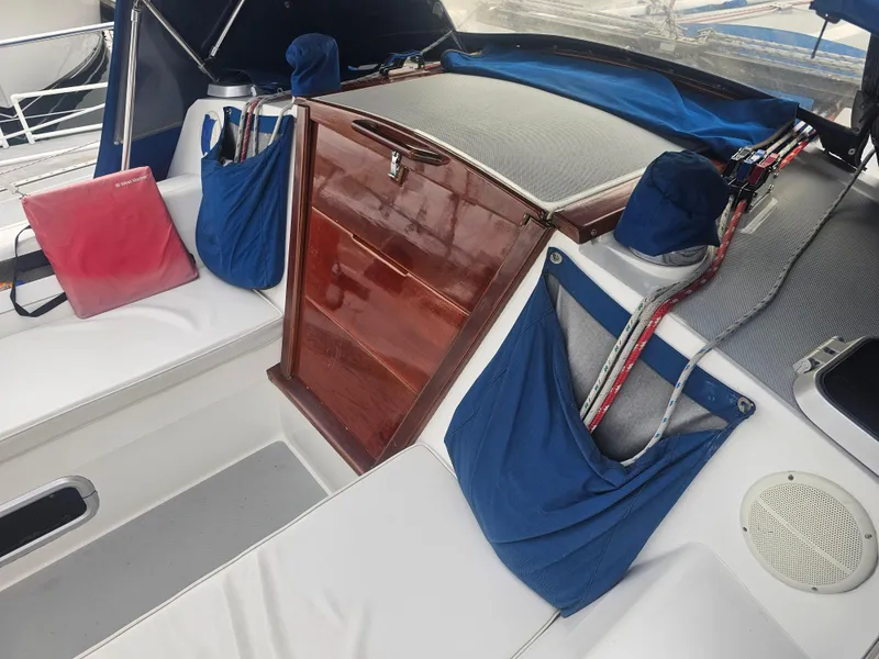 Slide: The Image of Interior of a 1990 Catalina 42 sailboat with wooden hatch and blue storage pockets. - 35