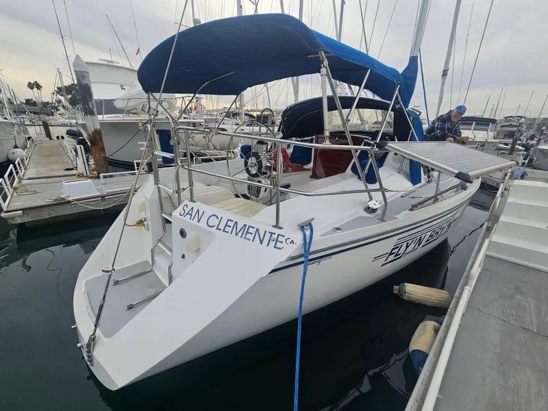 Slide: The Image of 1990 Catalina 42 sailboat docked in marina, San Clemente, blue canopy, white hull. - 38