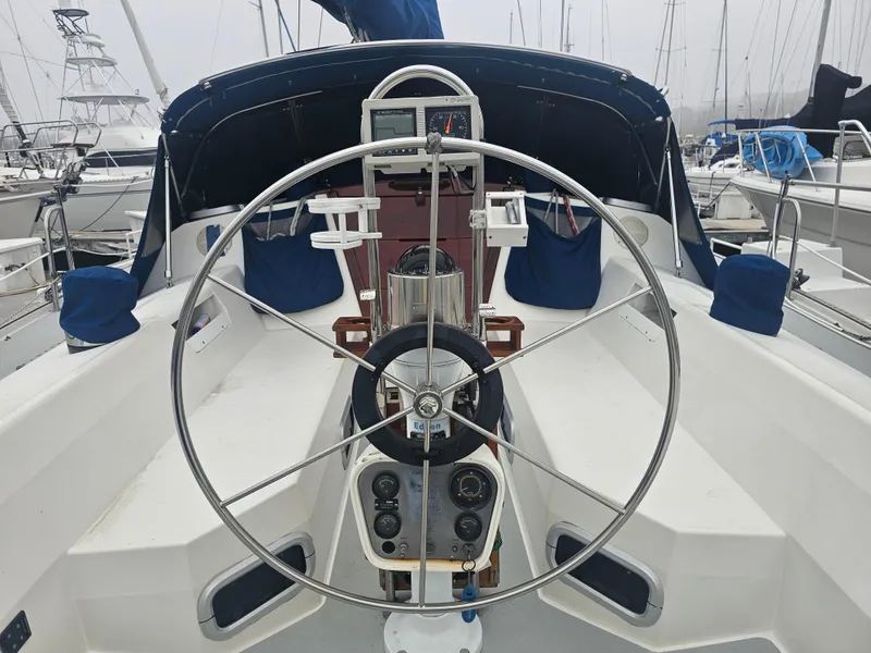 Slide: The Image of Cockpit of a 1990 Catalina 42 sailboat with steering wheel and navigation instruments. - 4
