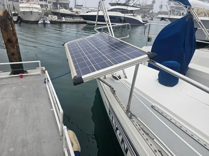 Slide: The Image of Catalina 42 sailboat with solar panel, docked in marina, overcast weather. - 6