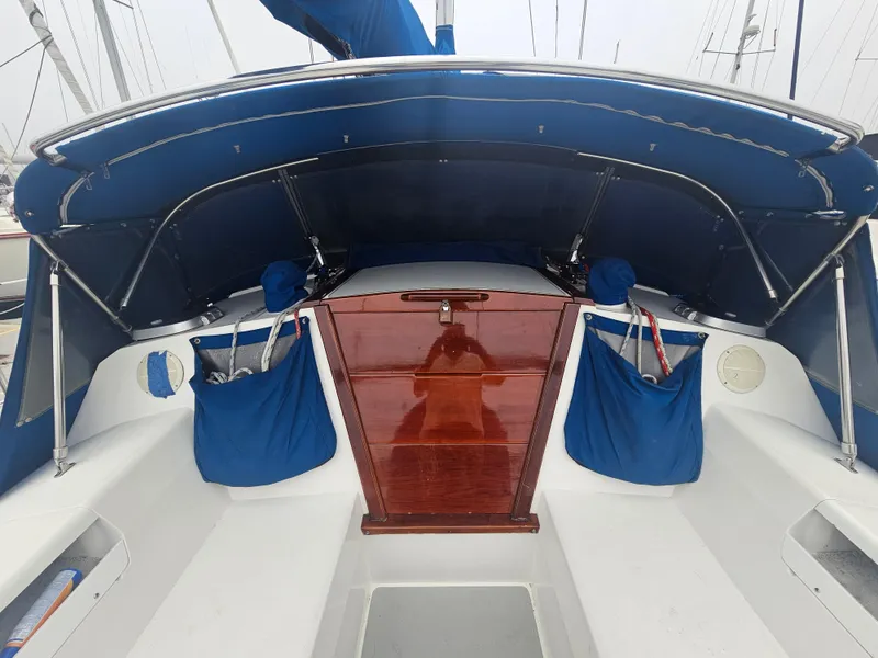Slide: The Image of Cockpit of 1990 Catalina 42 sailboat with blue canopy and wooden hatch. - 9
