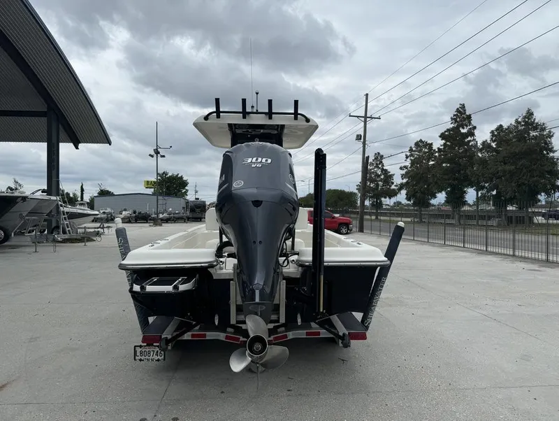 Slide: The Image of 2013 ShearWater LTZ Series 25 boat with powerful outboard motor, parked outdoors. - 11