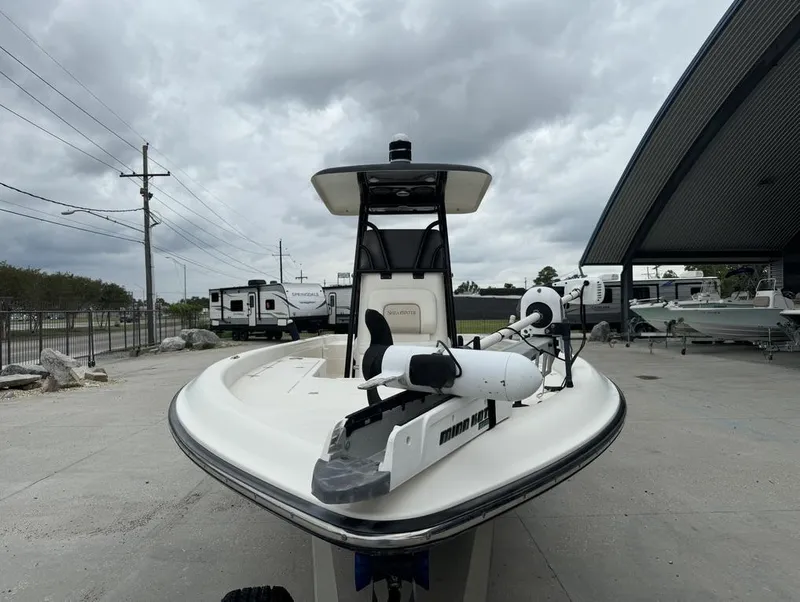Slide: The Image of 2013 ShearWater LTZ Series 25 boat with trolling motor, parked under cloudy skies. - 13