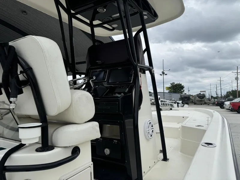 Slide: The Image of 2013 ShearWater LTZ Series 25 boat interior with steering console and seating. - 16