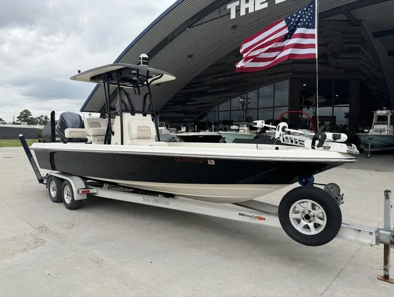 Slide: The Image of 2013 ShearWater LTZ Series 25 boat on trailer, American flag, outdoor showroom. - 3