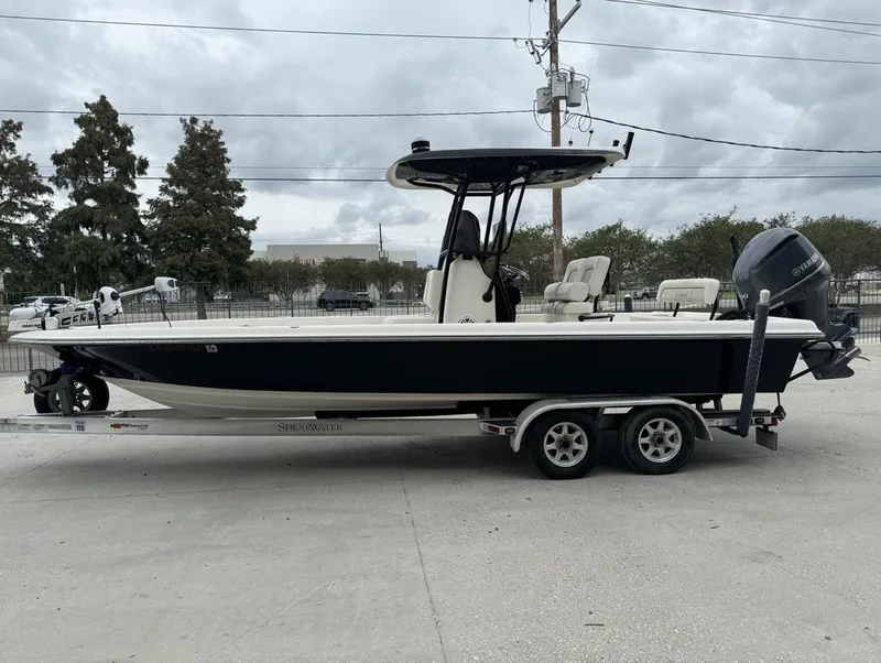 Slide: The Image of 2013 ShearWater LTZ Series 25 boat on trailer, parked outdoors under cloudy sky. - 4