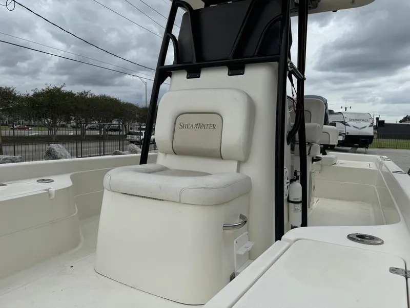 Slide: The Image of 2013 ShearWater LTZ Series 25 boat interior with seating and console. - 6