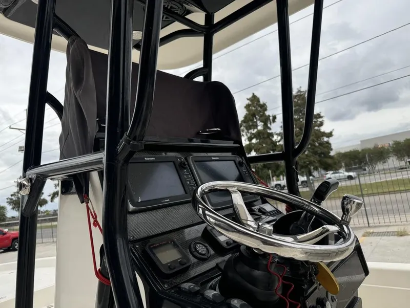 Slide: The Image of 2013 ShearWater LTZ Series 25 boat console with steering wheel and navigation equipment. - 8