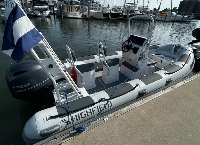 Slide: The Image of 2023 Highfield Patrol 540 boat docked at marina with Yamaha engine. - 1