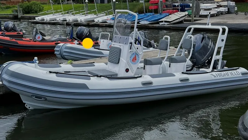 Slide: The Image of 2023 Highfield Patrol 540 boat docked at marina, featuring sleek design and modern equipment. - 2