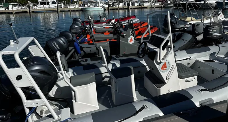 Slide: The Image of 2023 Highfield Patrol 540 boats docked at marina with Yamaha engines. - 3