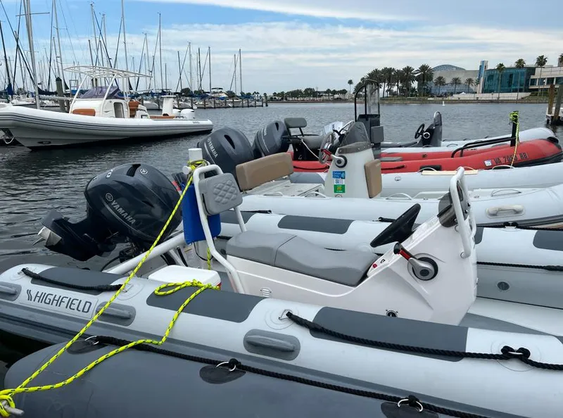 Slide: The Image of 2023 Highfield Patrol 460 boats docked at marina with other vessels. - 3