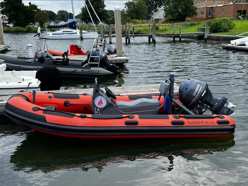 Slide: The Image of 2023 Highfield Patrol 460 inflatable boat docked in a marina. - 0
