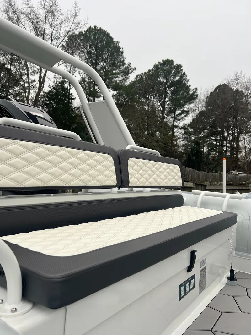 Slide: The Image of 2025 Highfield Sport 760 boat with quilted seating, outdoor setting. - 12