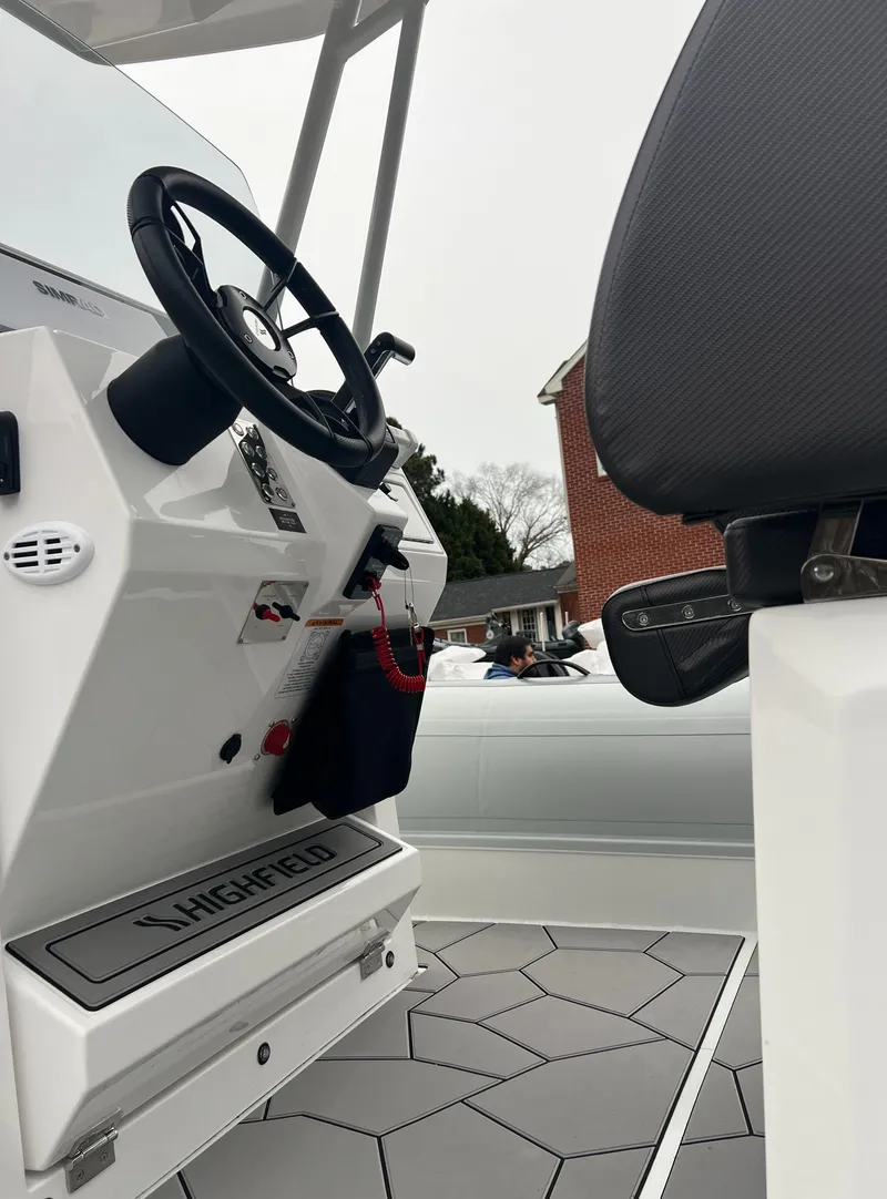 Slide: The Image of 2025 Highfield Sport 760 boat interior with steering wheel and seating. - 13