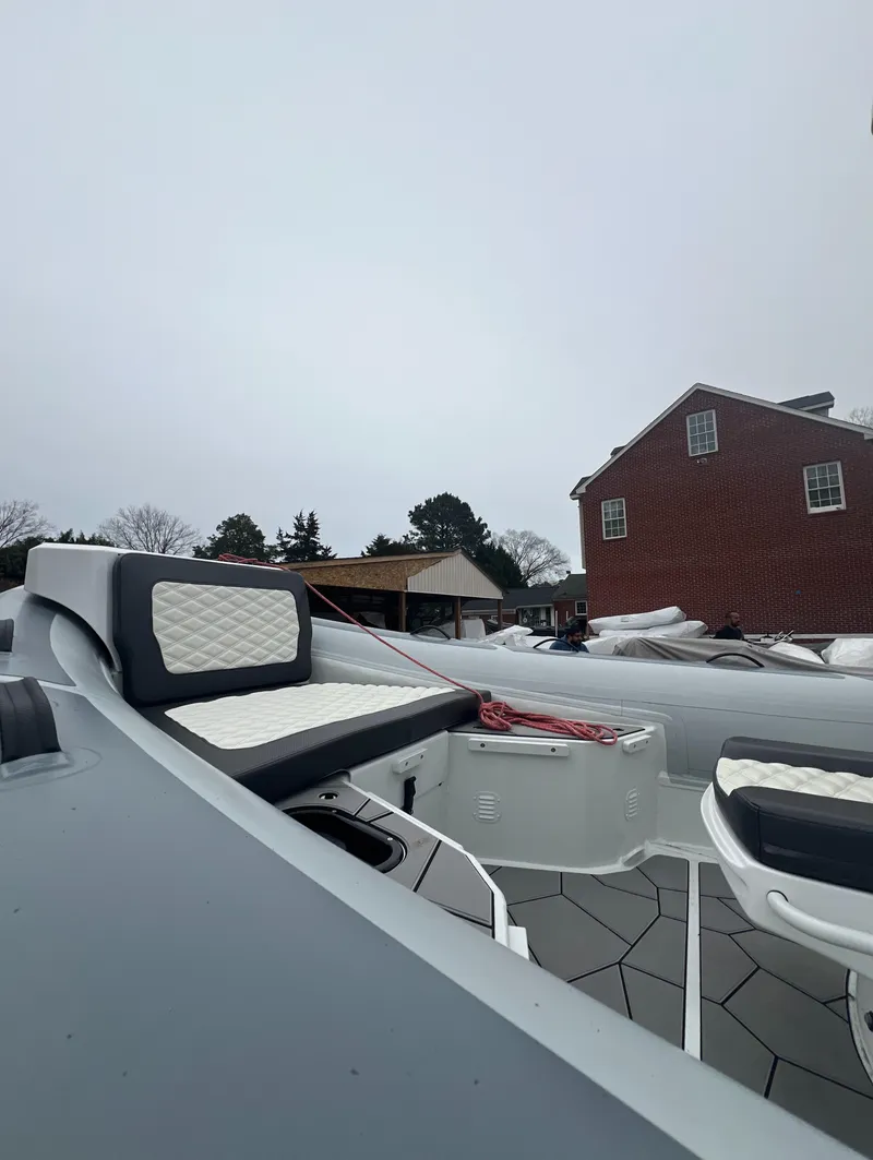 Slide: The Image of 2025 Highfield Sport 760 boat with sleek seating, snowy background, and overcast sky. - 8