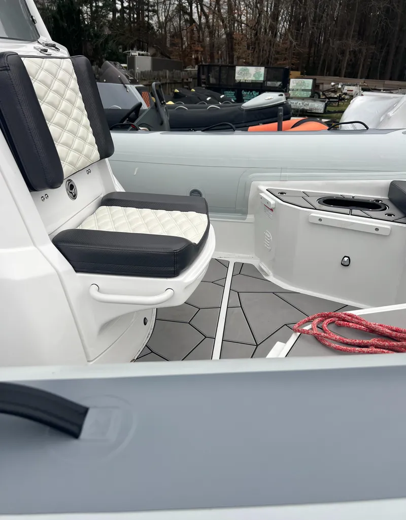 Slide: The Image of 2025 Highfield Sport 760 boat interior with cushioned seating and deck details. - 9