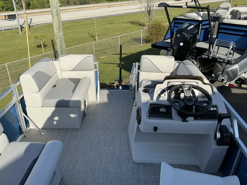 Slide: The Image of 2025 Tahoe Pontoon Boats Sport 17 REAR FISH interior with seating and steering console. - 4