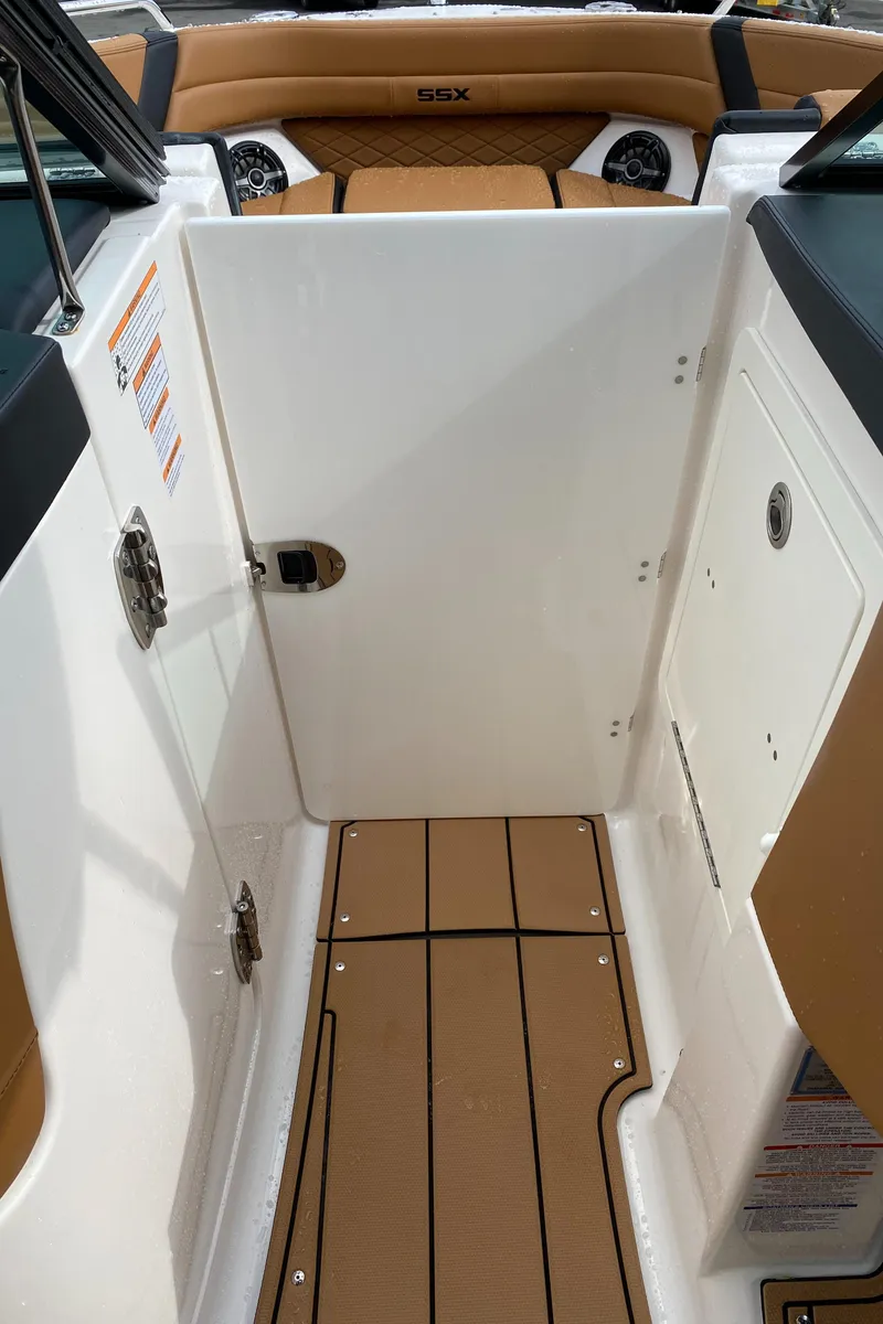 Slide: The Image of 2024 Chaparral 267 SSX boat interior with tan and white design. - 11