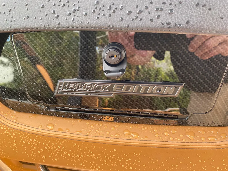 Slide: The Image of 2024 Chaparral 267 SSX Black Edition with carbon fiber detail and raindrops. - 16