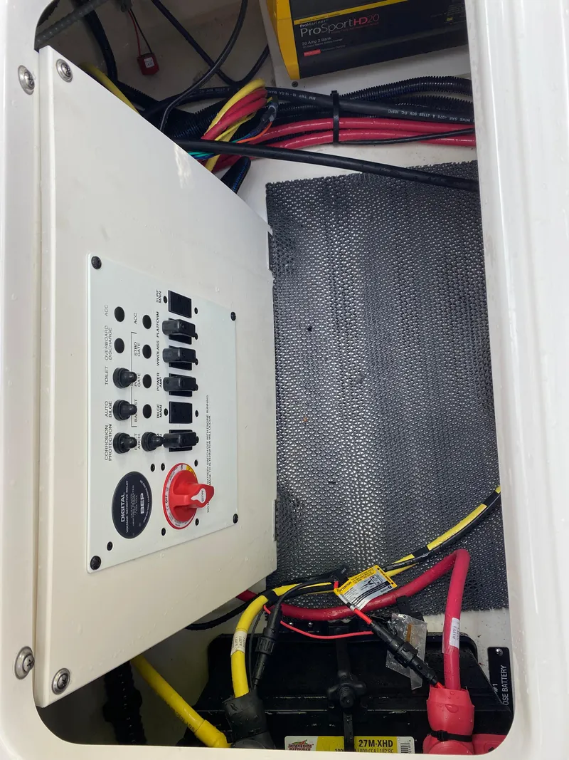 Slide: The Image of 2024 Chaparral 267 SSX electrical panel with wiring and battery connections. - 20