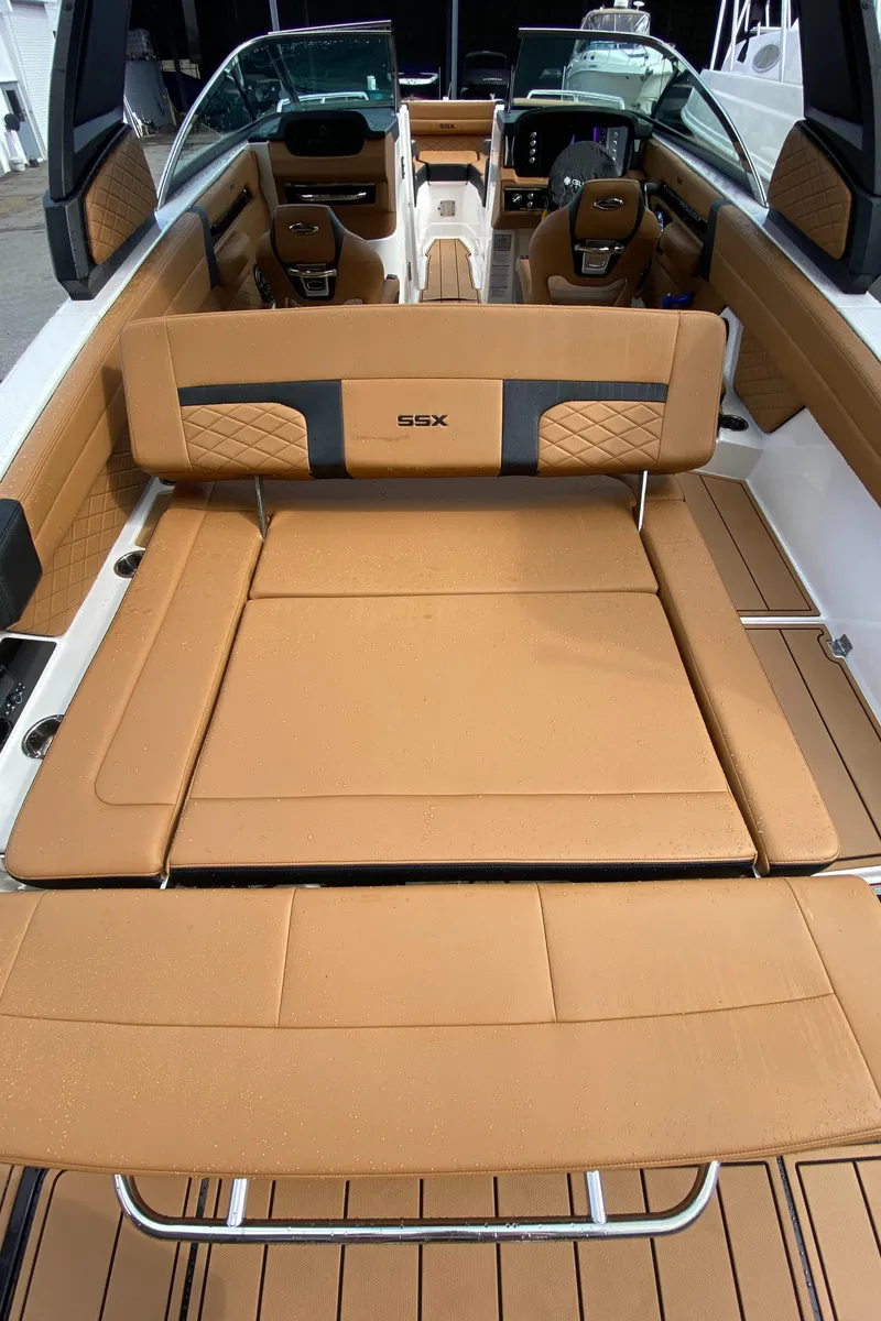 Slide: The Image of 2024 Chaparral 267 SSX boat interior with tan leather seating and modern design. - 6