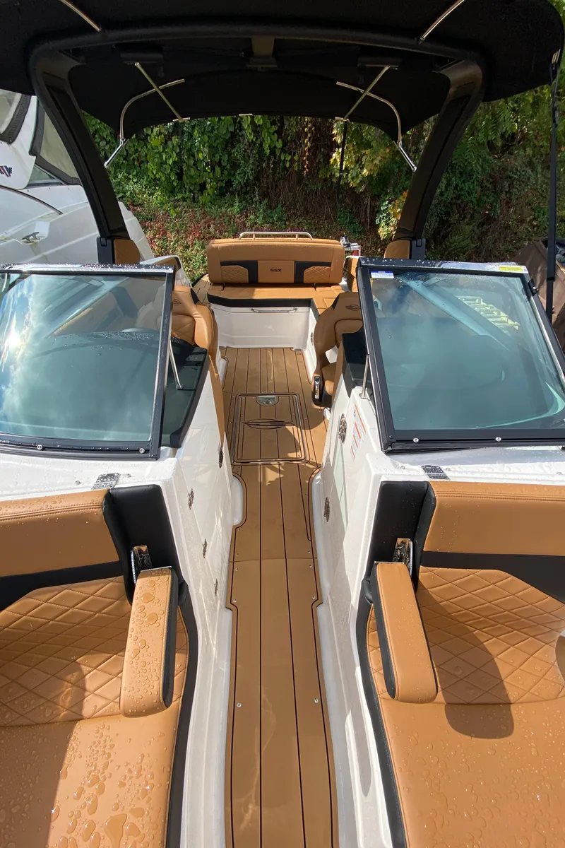 Slide: The Image of 2024 Chaparral 267 SSX boat interior with tan seating and sleek design. - 9