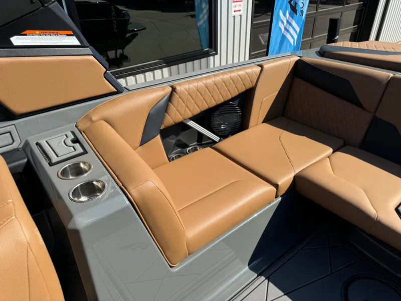 Slide: The Image of 2024 Tigé Z3 boat interior with tan leather seats and cup holders. - 16