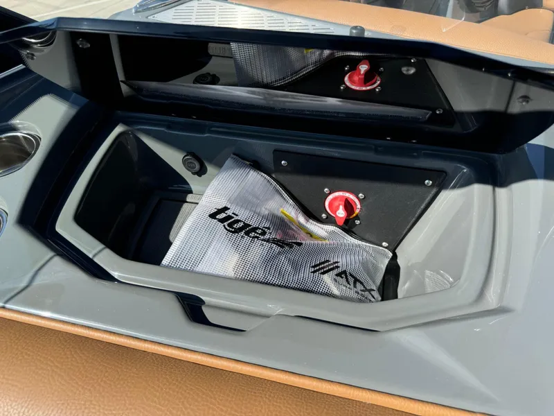 Slide: The Image of 2024 Tigé Z3 boat storage compartment with safety equipment and red control knob. - 21
