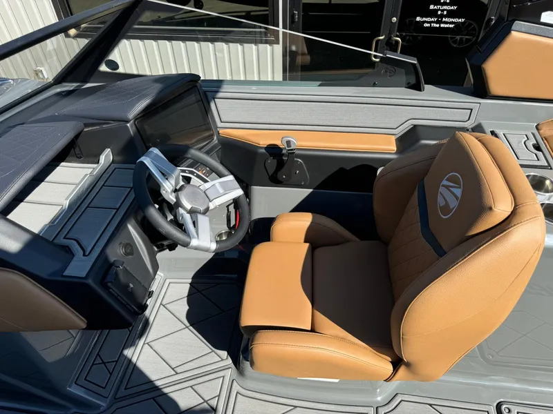 Slide: The Image of 2024 Tigé Z3 boat interior with tan leather seat and modern steering wheel. - 22