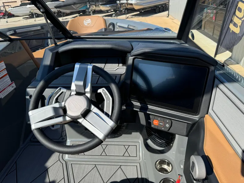 Slide: The Image of 2024 Tigé Z3 boat dashboard with steering wheel and touchscreen display. - 24
