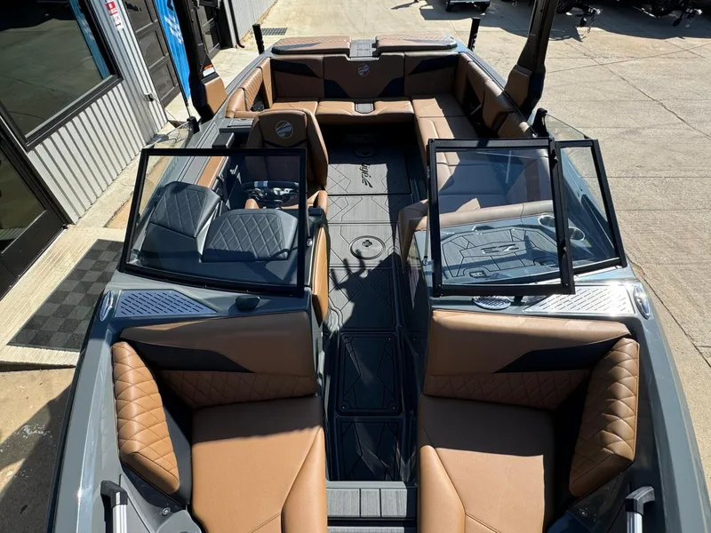 Slide: The Image of 2024 Tigé Z3 boat interior with brown leather seating and open windshield. - 31