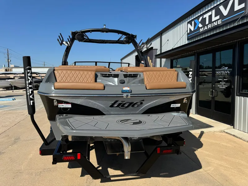 Slide: The Image of 2024 Tigé Z3 boat at NXT LVL Marine dealership, featuring sleek design and tan seating. - 4