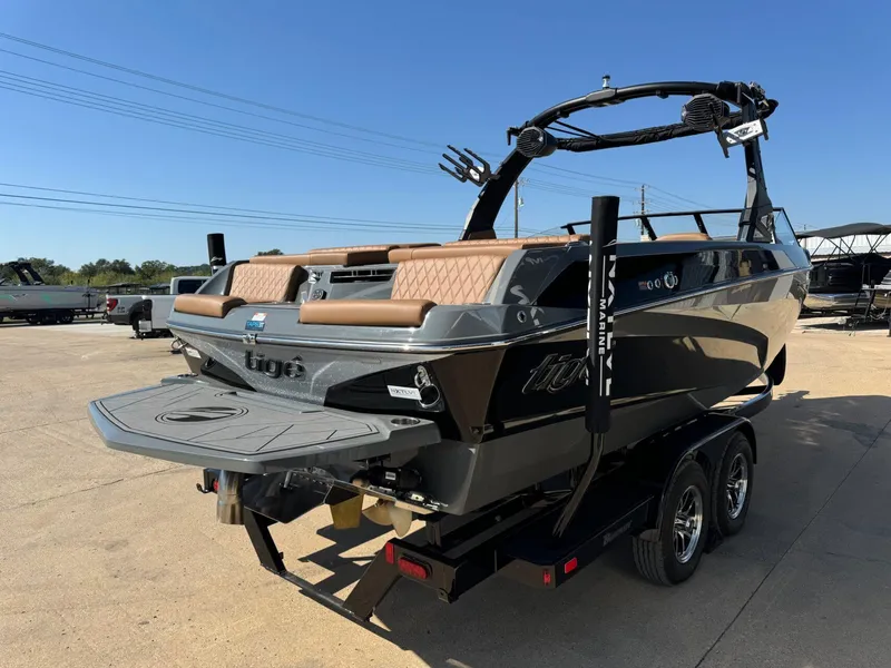 Slide: The Image of 2024 Tigé Z3 boat on trailer, featuring sleek design and tan seating. - 6