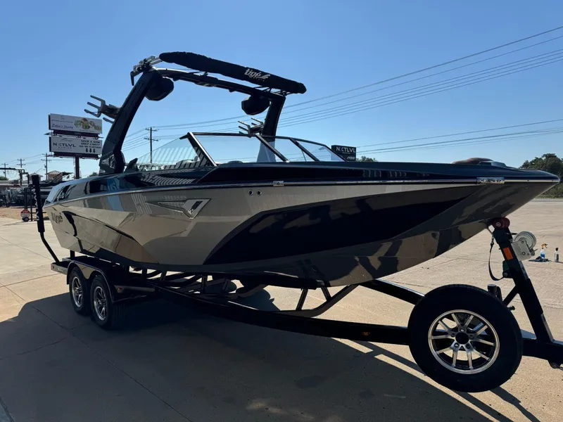 Slide: The Image of 2024 Tigé Z3 boat on trailer, sleek design, parked outdoors. - 7