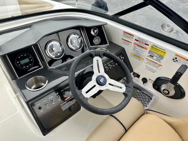 Slide: The Image of 2025 Bayliner VR6 Bowrider I/O dashboard with steering wheel and control panel. - 11