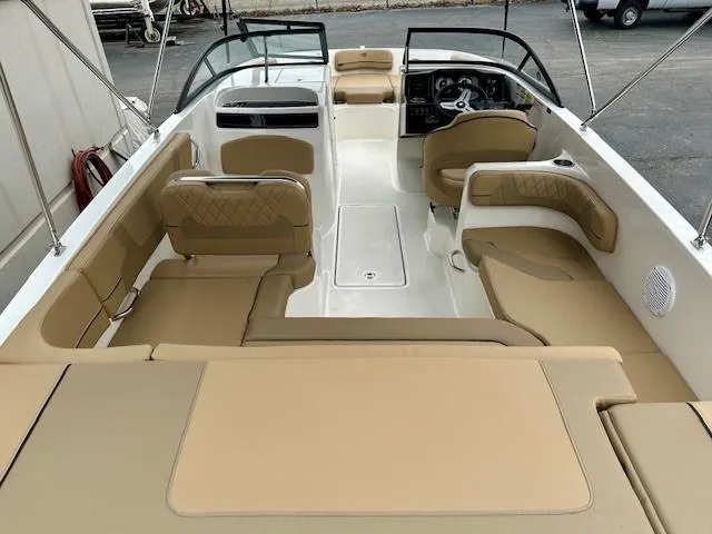 Slide: The Image of 2025 Bayliner VR6 Bowrider I/O interior with tan seating and modern dashboard. - 5