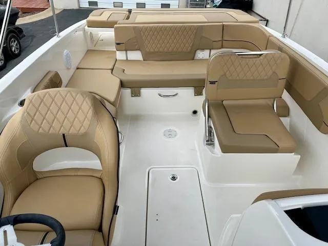 Slide: The Image of Interior of 2025 Bayliner VR6 Bowrider I/O with tan seating and modern design. - 7