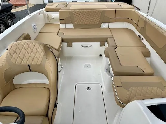 Slide: The Image of 2025 Bayliner VR6 Bowrider I/O with beige leather seating and spacious interior layout. - 9