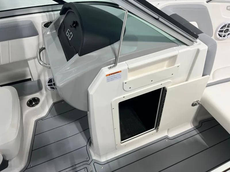 Slide: The Image of 2025 Chaparral 21 SSi boat interior with open storage compartment and sleek design. - 11