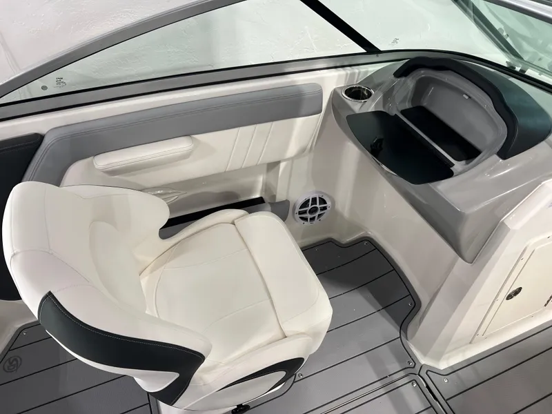 Slide: The Image of 2025 Chaparral 21 SSi boat interior with white seating and sleek dashboard design. - 12