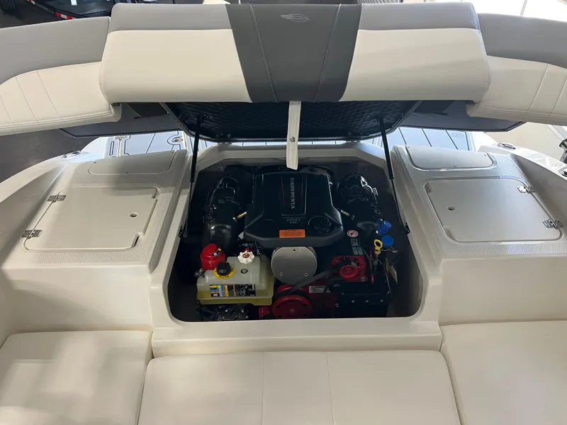Slide: The Image of 2025 Chaparral 21 SSi boat engine compartment with open hatch, showcasing engine details. - 14