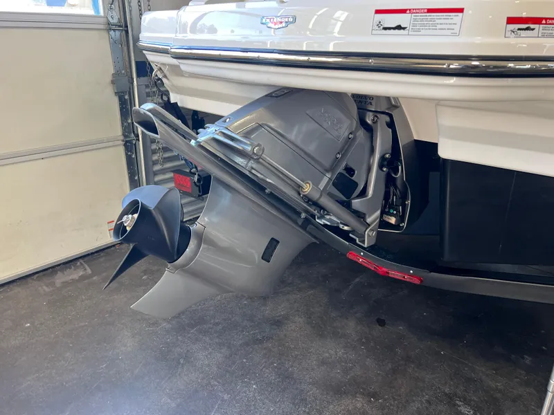 Slide: The Image of 2025 Chaparral 21 SSi boat stern drive in a garage setting. - 16