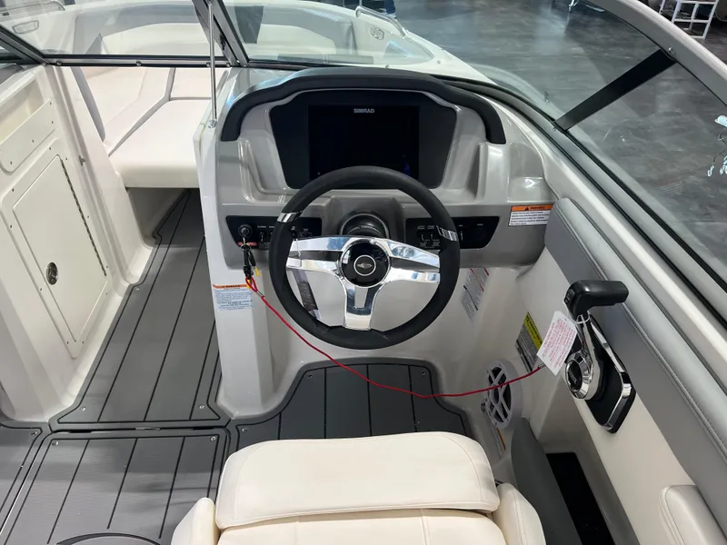 Slide: The Image of Interior view of 2025 Chaparral 21 SSi boat cockpit with steering wheel and controls. - 5