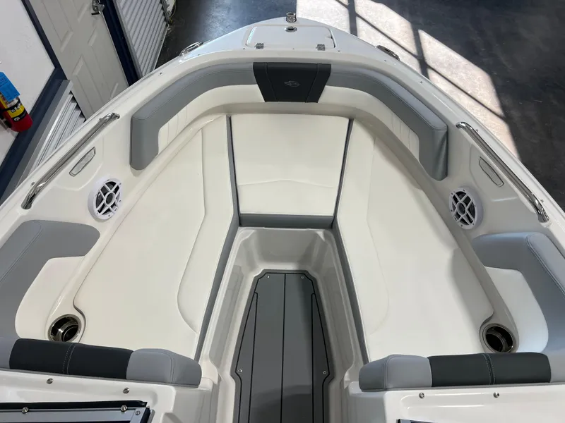 Slide: The Image of 2025 Chaparral 21 SSi boat interior with gray and white seating, speakers, and cup holders. - 8