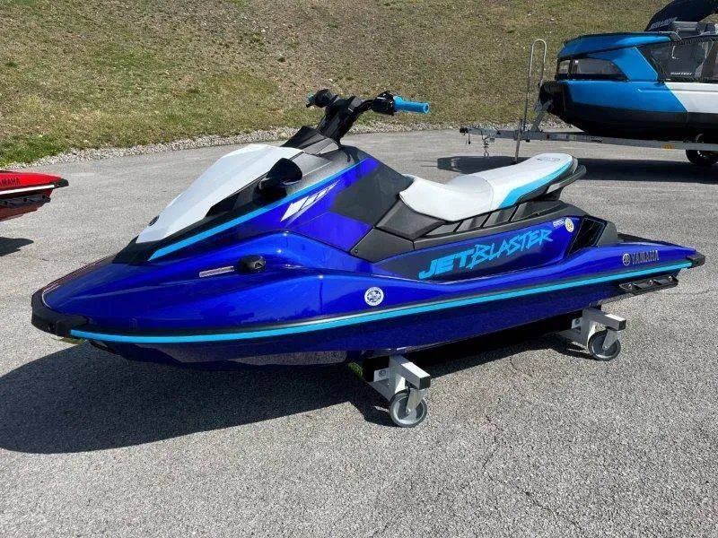 Slide: The Image of 2024 Yamaha Waverunner Jet Blaster in vibrant blue on display outdoors. - 1