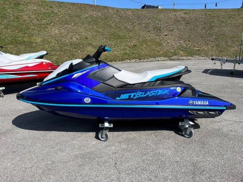Slide: The Image of 2024 Yamaha Waverunner Jet Blaster in blue, parked on pavement. - 2