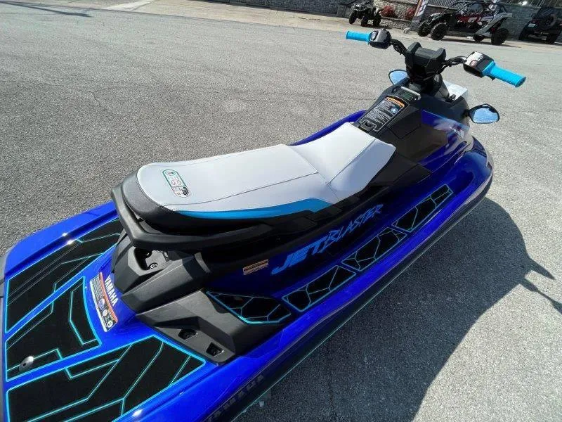 Slide: The Image of 2024 Yamaha Waverunner Jet Blaster, blue and white, parked on pavement. - 32