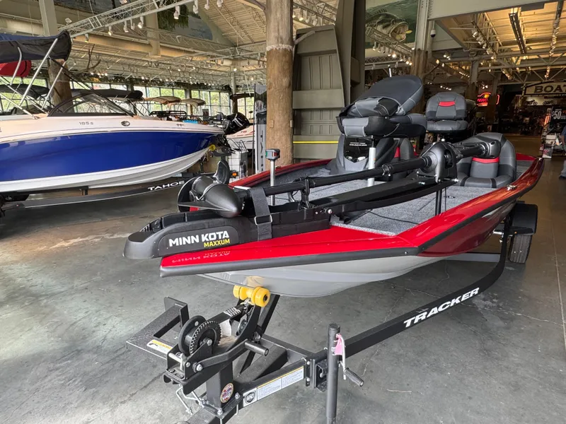 Slide: The Image of 2025 Tracker Pro Team 175 boat with Minn Kota motor in showroom. - 2